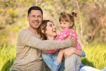 Happy family resting in park