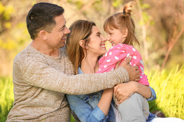 Happy family resting in park