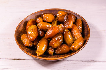 Date fruits on the white wooden table