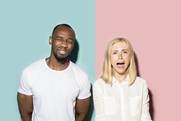 Fototapeta premium Man and woman posing at studio during quarrel