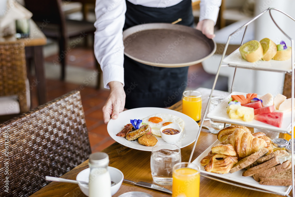 Wall mural Waitress serving breakfast at a restaurant