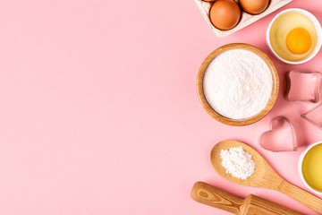 Ingredients and utensils for baking on a pastel background.