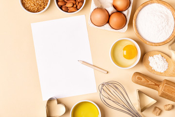 Ingredients and utensils for baking on a pastel background.