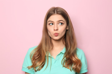 Fototapeta premium Emotional young woman on color background
