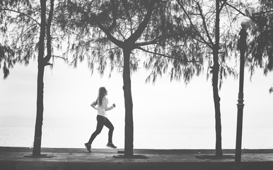 A woman jogging on a beach