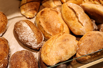 Delicious fresh bread on shelf in bakery