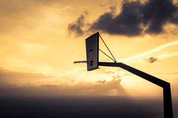 basketball basket against sunset sky