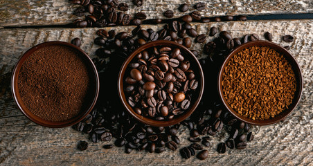 Coffee assortment. Closeup of three coffee types in cups on rustic wooden table. 