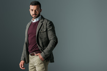 handsome bearded man posing in autumn tweed jacket, isolated on grey