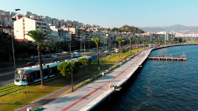 Tram of Izmir riding along the sea side of the city.