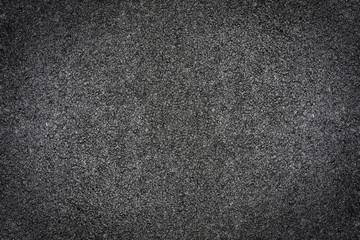 Black asphalt street as closeup and background with copy space