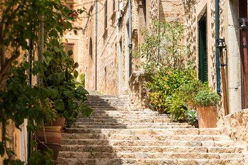 Mediterranean alley in Spain with ancient houses and idyllic atmosphere