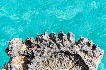 Closeup of rock and blue mediterranean sea as background