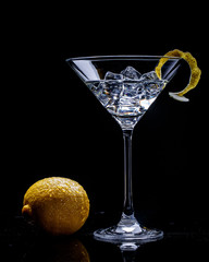 lemon and glass with martinion black background - 216116819