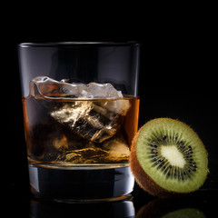 a glass with whiskey and ice on a background - 216116842