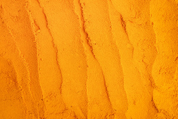 Turmeric powder texture nature background. Herbal