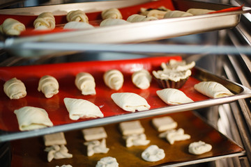 dessert baking on baking trays in the oven - 216117477