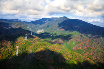 Autumn green energy concept Electricity station Electricity plant on mountain landscape over blue sky in ashirayama kyoto Japan..