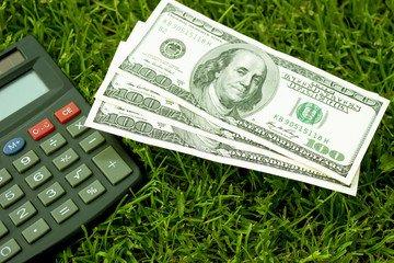 One hundred American dollars and a calculator