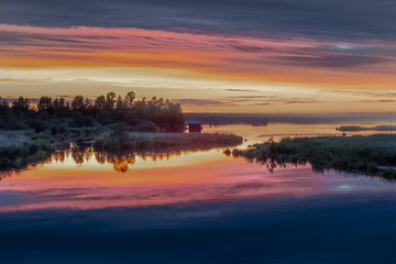 Pink sunset on the lake shore
