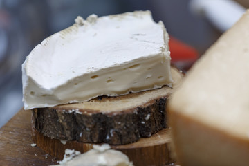 Camembert cheese on wooden background