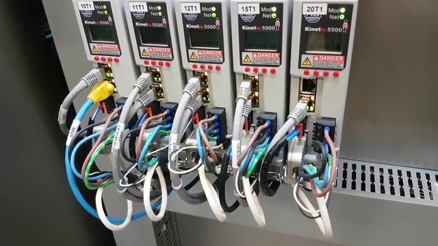 Working servo drive in electrical cabinet of a machine with leds CLOSE UP right to left.