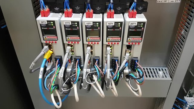 Working servo drives in electrical cabinet of a machine with leds CLOSE UP front.