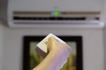 hand with remote control air conditioning, close-up