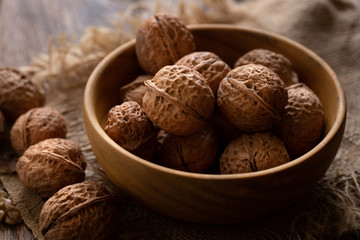 Walnuts kernels in wooden bowl, Walnut healthy food Top view