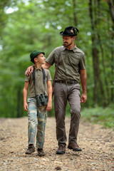 Fototapeta premium Ranger and his son in the woods