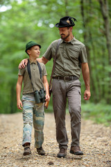 Ranger and his son in the woods