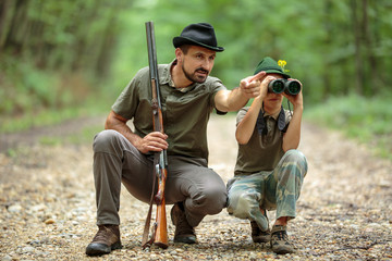 Ranger and his son in the woods