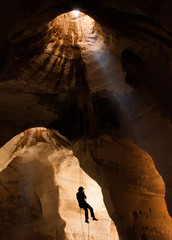 Silhouette of training alpinist in Luzit caves. Moshav Luzit, Ella Valley. Israel