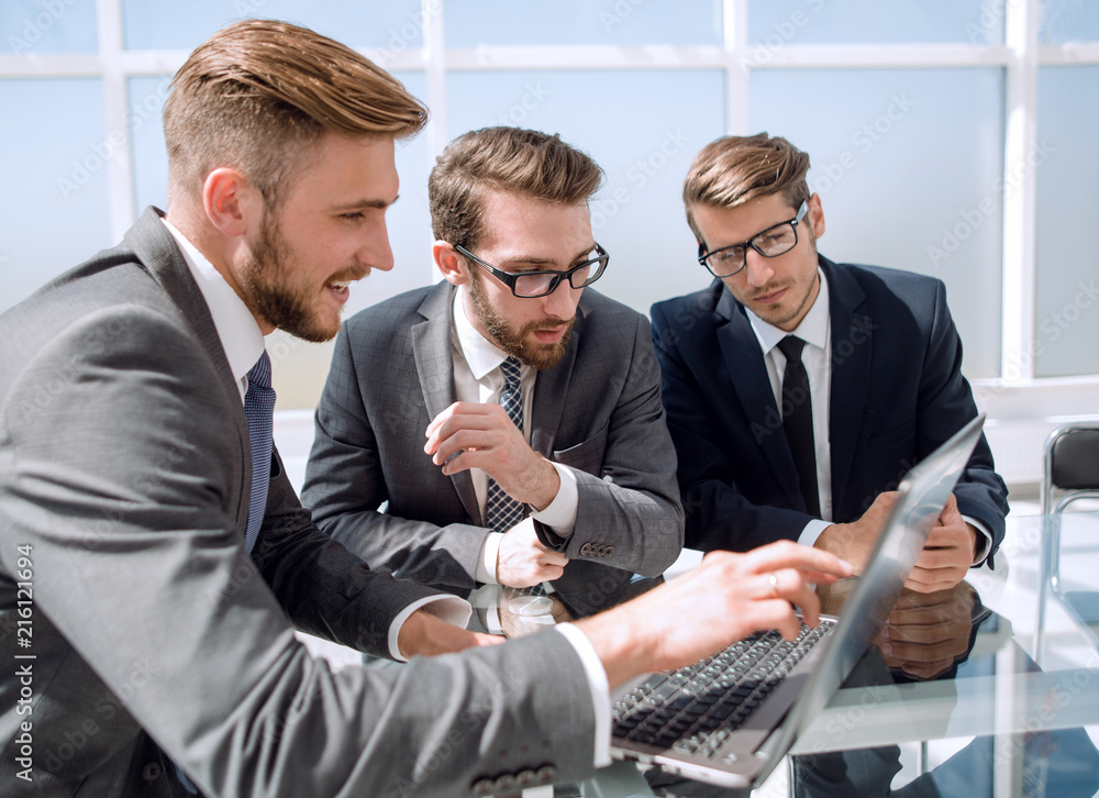 Canvas Prints three businessman sitting at his desk