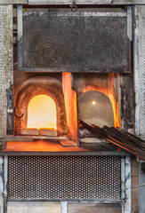 Italy, Venice, Murano glass factory special glass-blowing tools: red-hot furnace with fire to make the glass malleable, and iron rods (pontello).