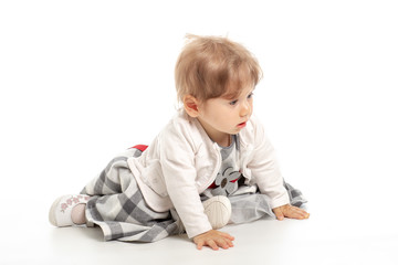 Elegant baby girl 1 year old sitting on the studio floor. White Background.