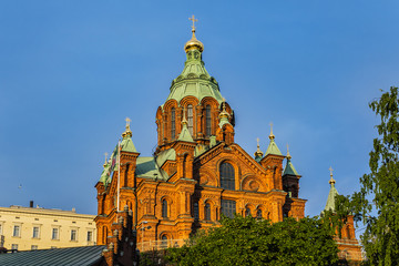 Fototapeta na wymiar Uspenski cathedral (Uspenskin katedraali, 1862 - 1868), dedicated to Dormition of Theotokos (Virgin Mary). Sunset. Helsinki, Finland.