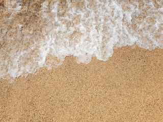 Ocean wave on sandy beach
