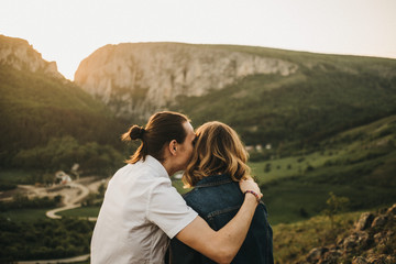Couple embracing near valley and mountains