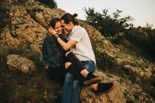 Couple kissing on mountain slope