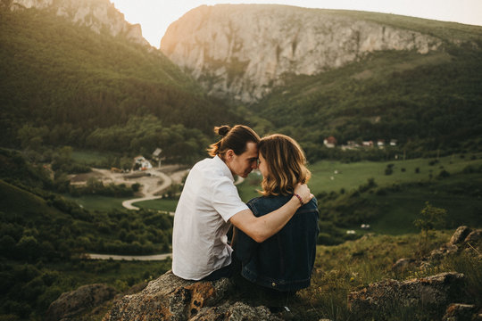Couple embracing near valley and mountains