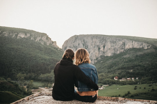 Couple embracing near valley and mountains