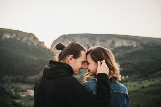 Couple embracing near valley and mountains