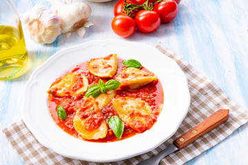 Delicious pasta - ravioli in tomato sauce with basil