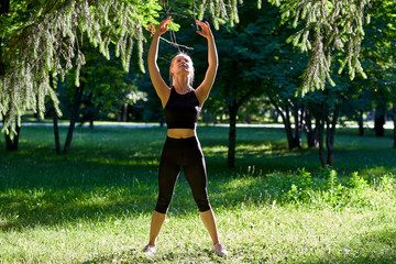 Yoga. Young woman practicing yoga or dancing or stretching in nature at park. Health lifestyle concept