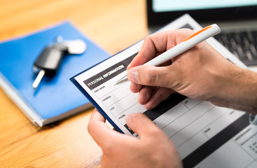 Car insurance form, bank loan, lease agreement or repair contract. Man writing personal information...