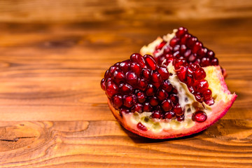 Pieces of the garnet fruit on wooden table