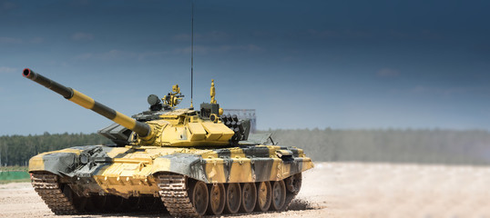 Military armored tank driving in mud at the open field