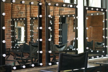 make up room with mirrors and lamp bulbs