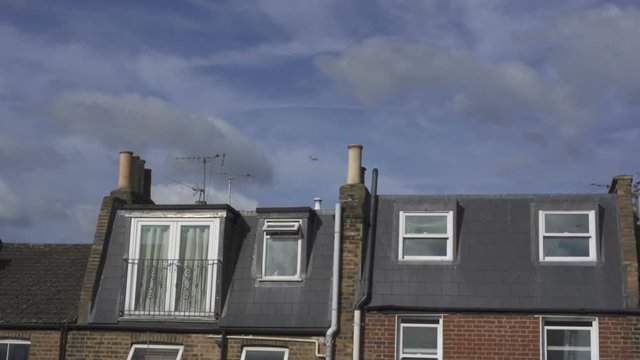Plane flies in the sky above house